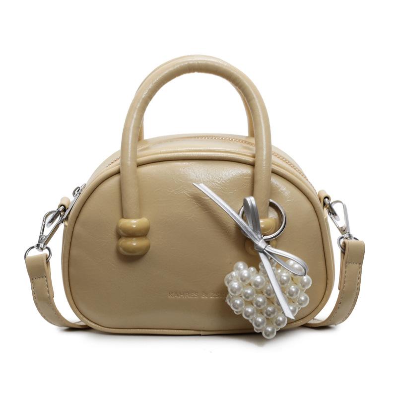 Korean version of the hot-selling cream style portable bowling bag, girls' fashion and advanced sense, foreign style versatile simple messenger bag