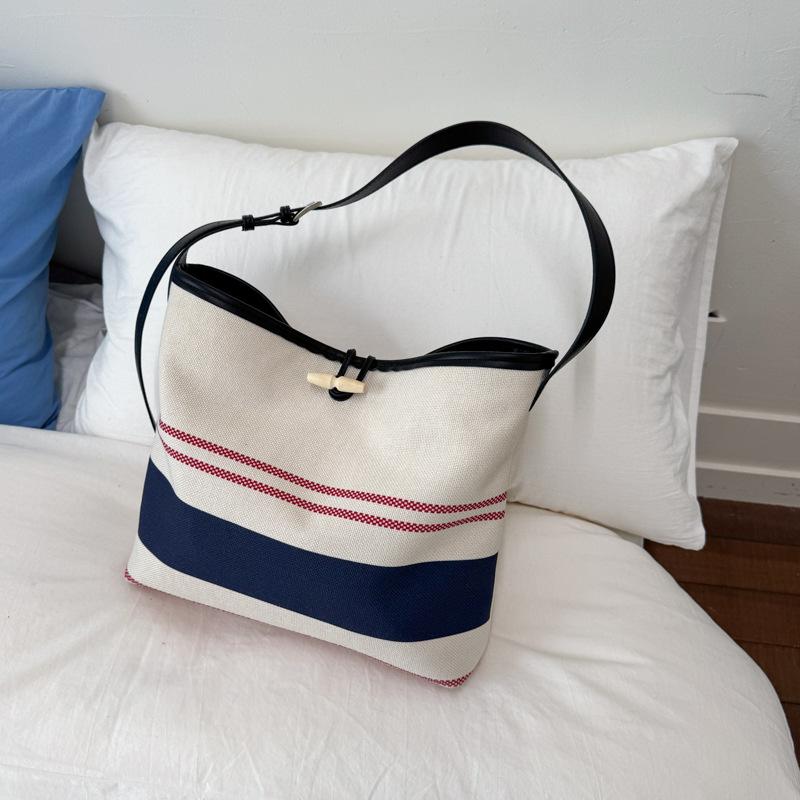 

Niche high-value handbag small bag women s 2025 new striped canvas bag fashionable shoulder crossbody bucket bag