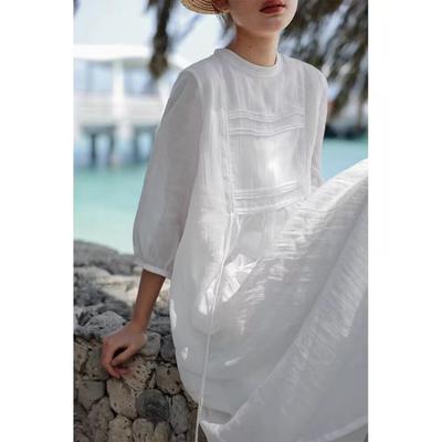A Woman In A Double Layered Mid Length White Dress
