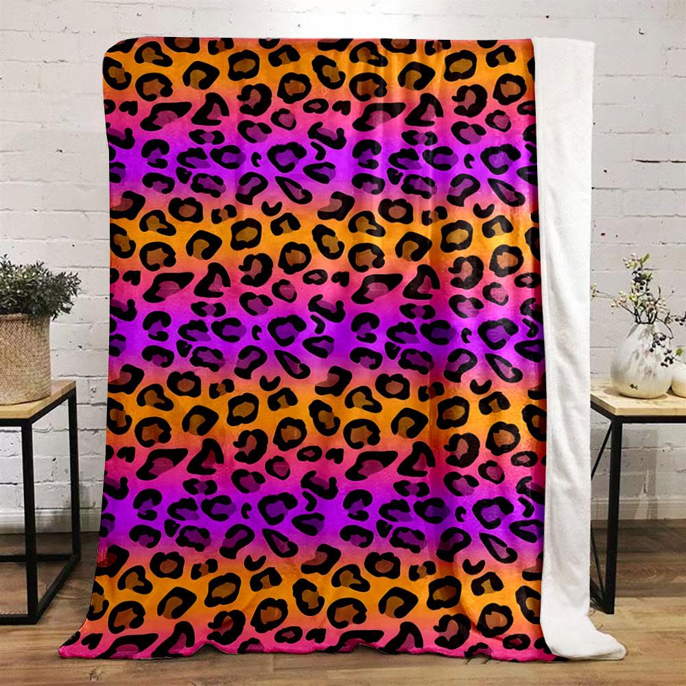 Black leopard spots on a gradient background of orange, pink, and purple. for all seasons blanket lunch break throw gift
