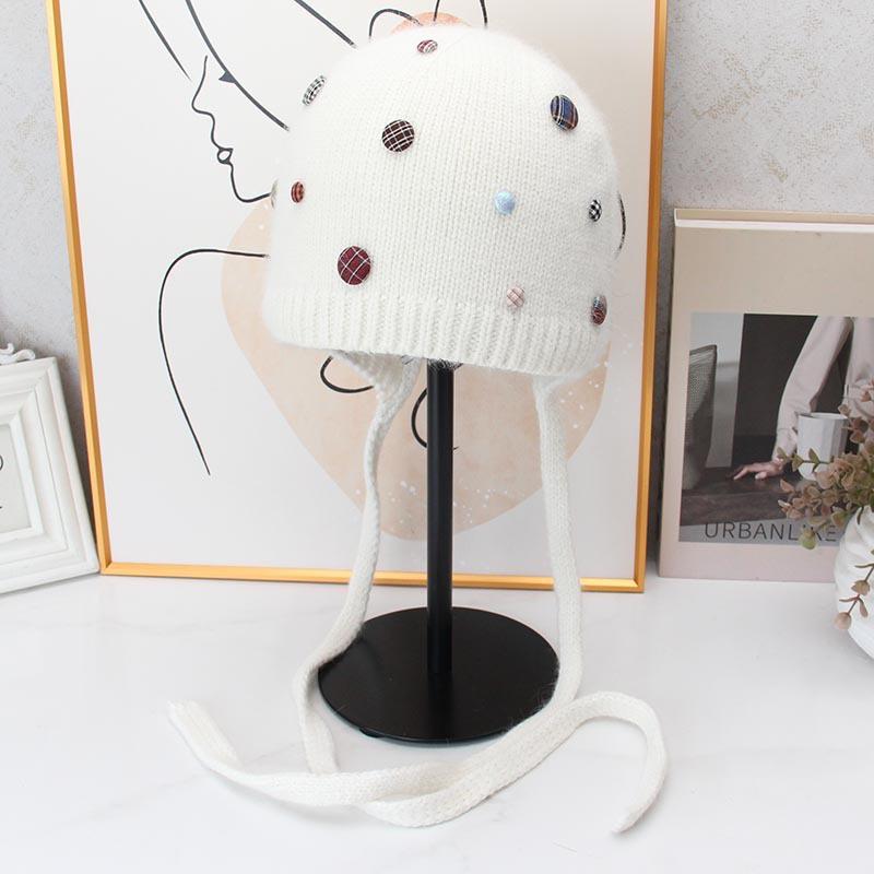 Autumn and winter Angola rabbit fur ear protection knitted hat women's color button decorative lace-up wool hat outdoor cold hat tide