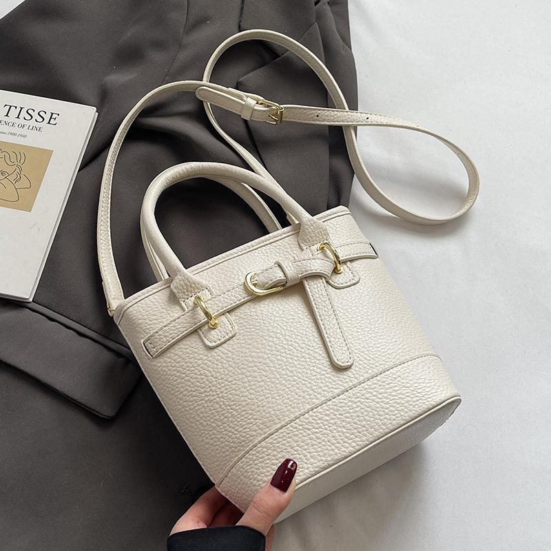 Hot sale in spring and summer Korean simple lychee pattern texture portable bucket bag casual commuting versatile solid color messenger women's bag