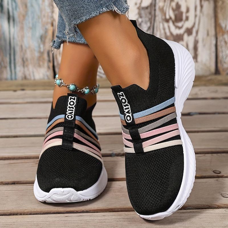 The Lady Wears Slip-On Casual Sports Shoes, Featuring a Breathable Mesh Design with Pastel Stripes, Suitable for Tennis And Comfortable