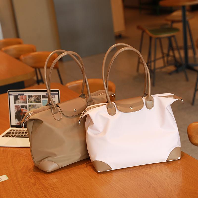 Simple and casual handbag tote bag, dumpling bag, women's briefcase, niche high-end large-capacity crossbody commuter bag