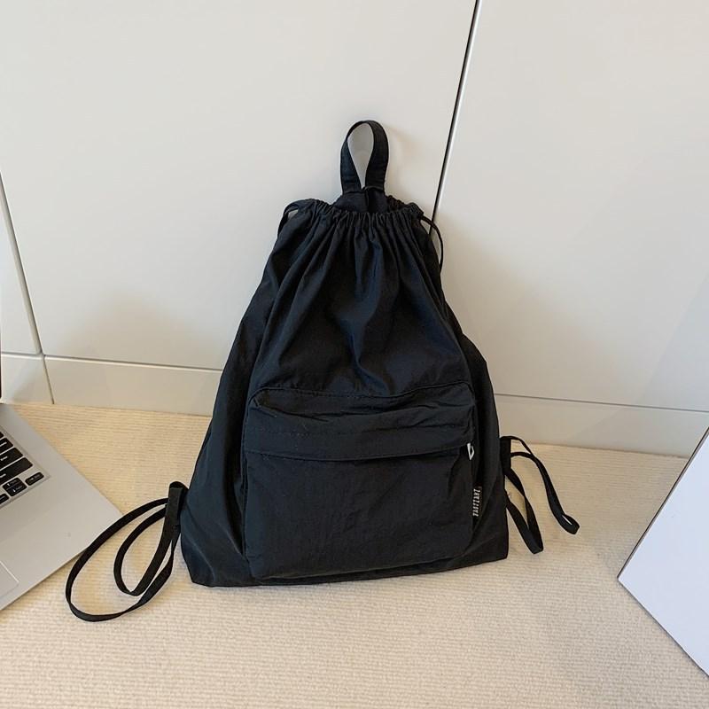 Japanese new simple light backpack commuter backpack drawstring pocket casual sports backpack men's and women's school bags