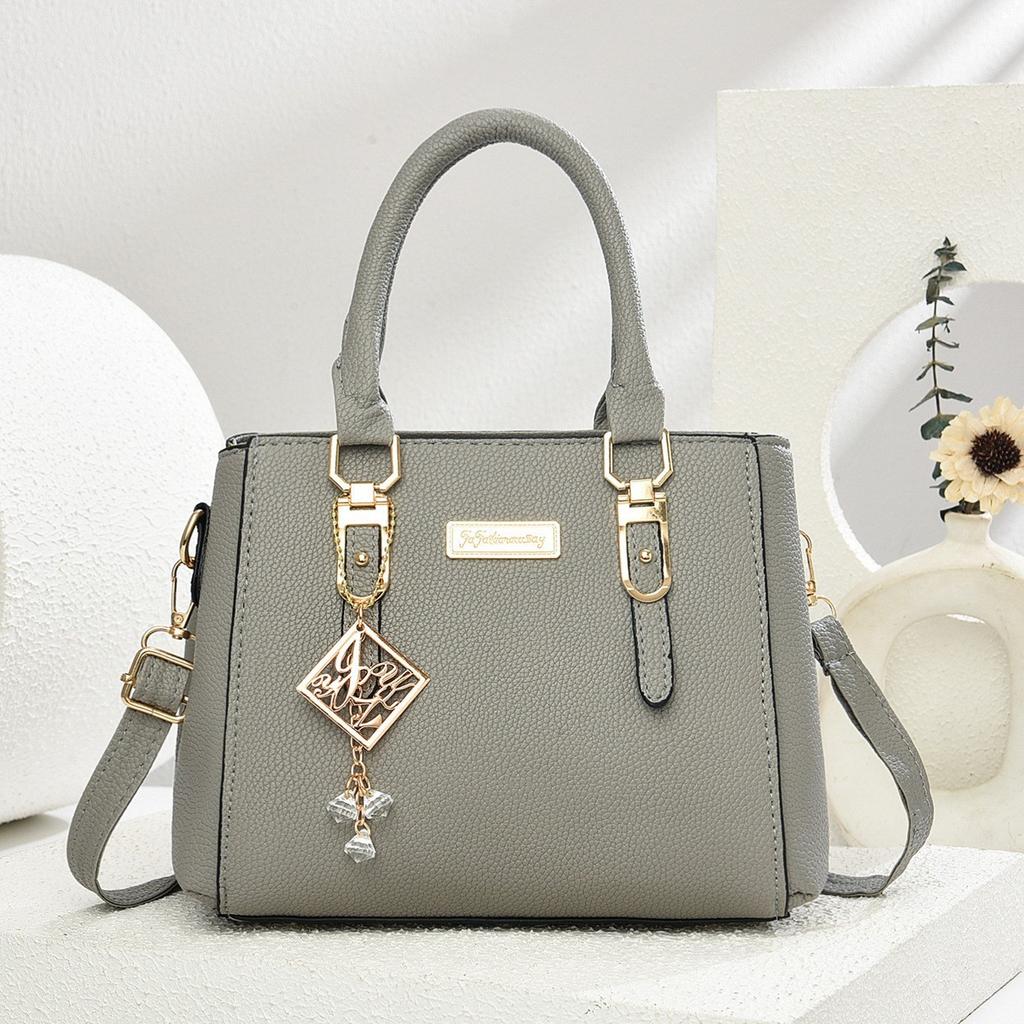 Simple and large-capacity hot-selling handheld women's bags 2026 new fashionable and versatile PU material single shoulder oblique span small