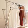 Stainless steel foldable and extendable clothes drying rack for indoor and outdoor use, suitable for futon drying. Also suitable for balconies and ind