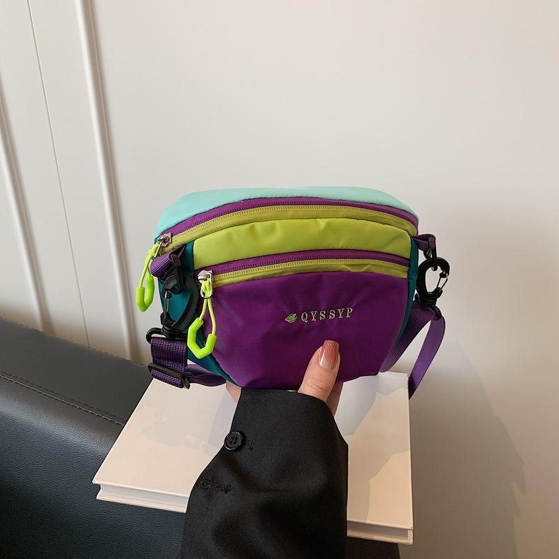 

Fashion dopamine contrasting color messenger bag Men s and women s same outdoor sports mountaineering portable waterproof nylon messenger bag фиолетовый