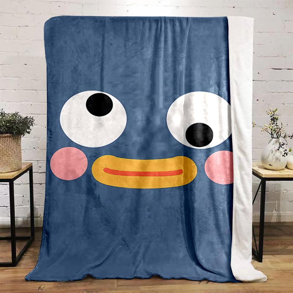 A cute cartoonish face with wide eyes, pink cheeks, and a yellow beak. for all seasons blanket lunch break throw gift