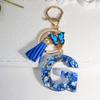 1pc Custom Blue Alphabet Letter Keychain with Butterfly Pendant Resin Ladies Key Ring with Tassel - Elegant Accessory for Bags Backpacks