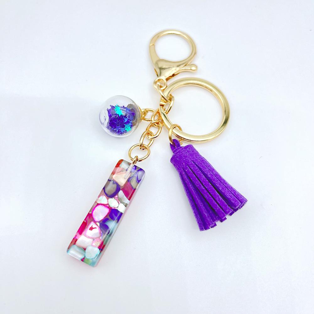 Europäischer und Amerikanischer Bestseller Englischer Initialschlüsselanhänger mit Lila Quasten-Accessoire