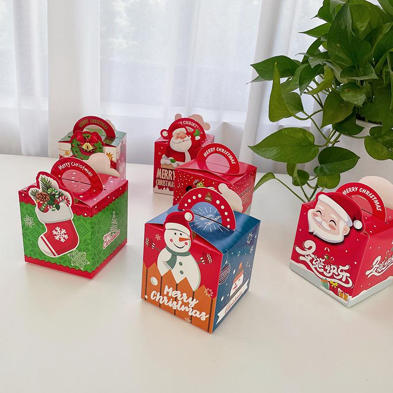 

Сложенная вручную рождественская подарочная коробка с яблоками