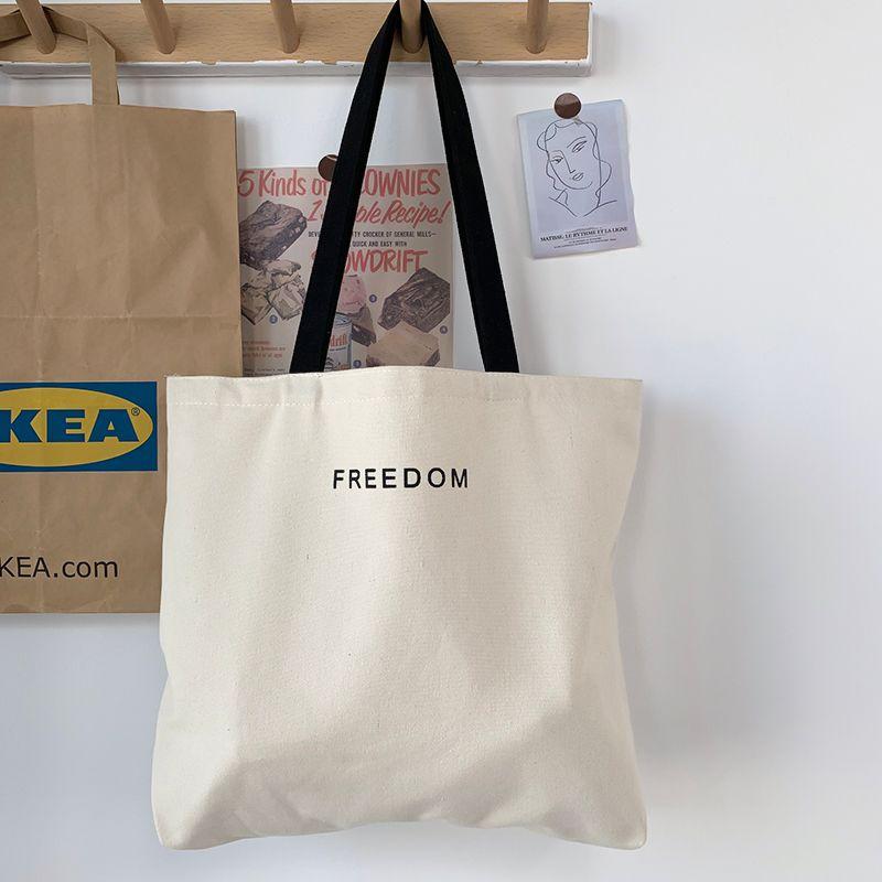 

Korean Series Simple Letter Large Capacity Canvas Bag Unisex Work Student Commuter Leisure Shopping Handbag FREEDOM without pendant