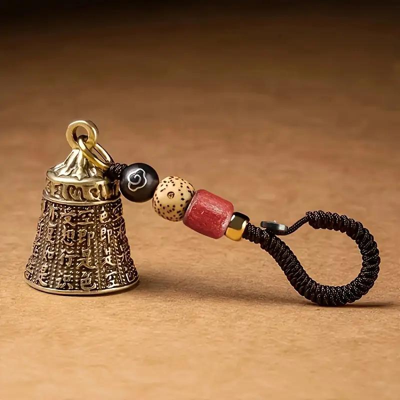 Handcrafted Antique Tibetan Bell Keychain with Braided Cord & Beads, Intricate Carvings золотой