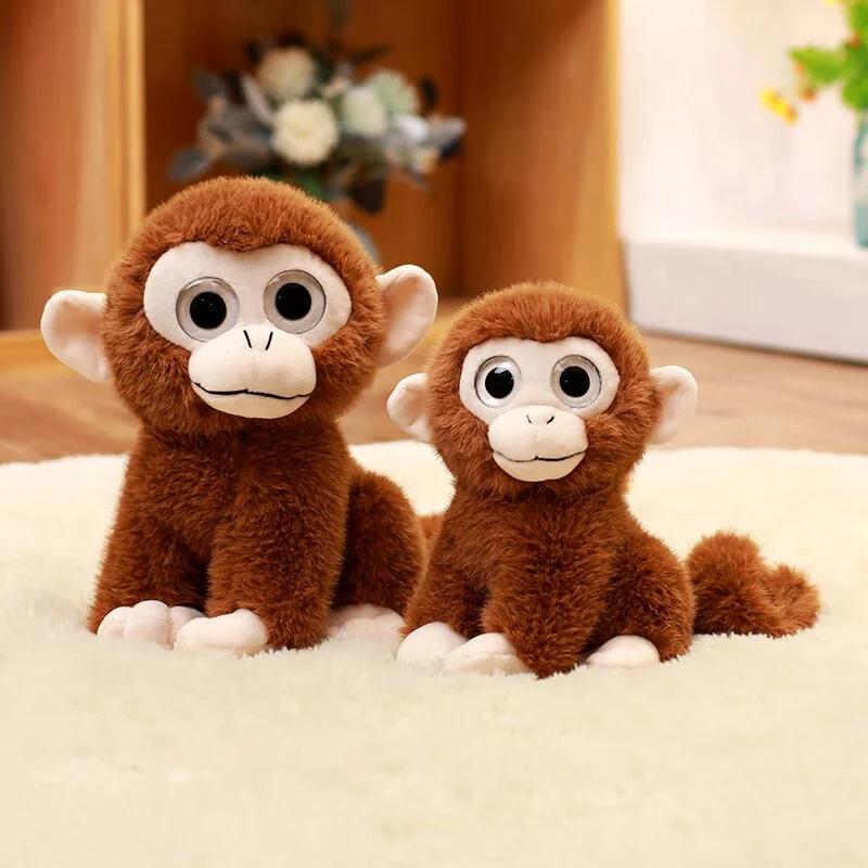 Plüschaffe mit großen Augen, weich und mit langem Schwanz, ideal als Dekoration oder Geburtstagsgeschenk für Kinder.