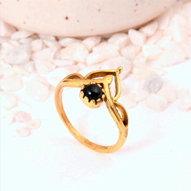Ornate Black Onyx Crown Ring: Gold-toned jewelry with a round black cabochon and a delicate lotus or tiara-style setting.