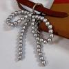 ZAKOL Y2K Coreano Carino Portachiavi con Perle e Fiocco in Perline per Donne Ragazze Ciondolo a Forma di Fiocco in Metallo Accessori Decorativi per Borsa