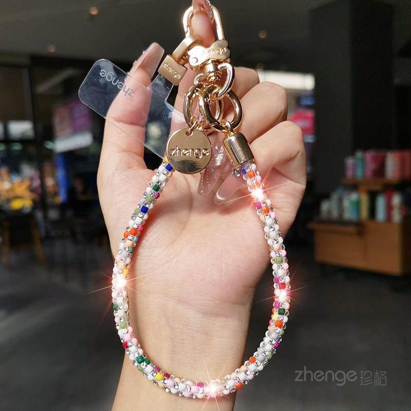 

Mobile phone lanyard female wrist shiny diamond unique and super good-looking, light luxury niche, exquisite high-end, short outdoor tourism