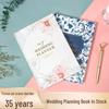 Grenzüberschreitender Hochzeitsplaner: Notizbuch mit Blumenmotiv und Heißprägung