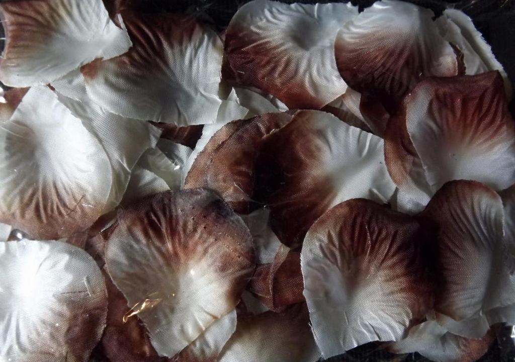Fabric rose petals packed in a white and brown bag