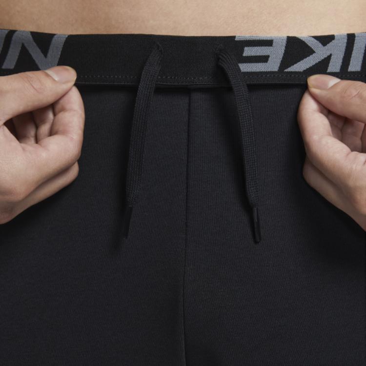 Nike Spodnie dresowe męskie z nadrukiem logo i elastycznym pasem Czarne FD9897-010