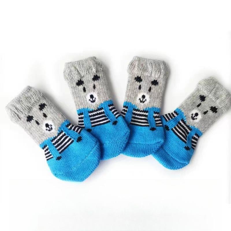Four-pack of autumn/winter cartoon anti-slip socks for pets, including cat and dog warm socks with paw prints, perfect as a holiday gift.