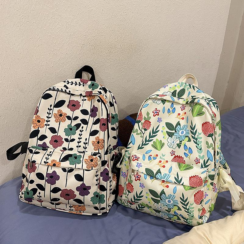 High-value schoolbag women's large capacity new fashion small floral backpack Japanese junior high and high school student backpack