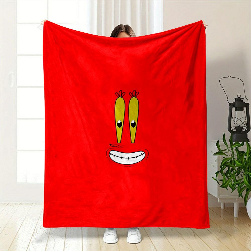 A cartoonish smiling face with big yellow eyes on a red background. for all seasons blanket lunch break throw gift