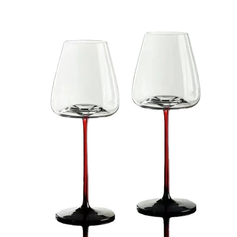 Two sets of red wine glasses