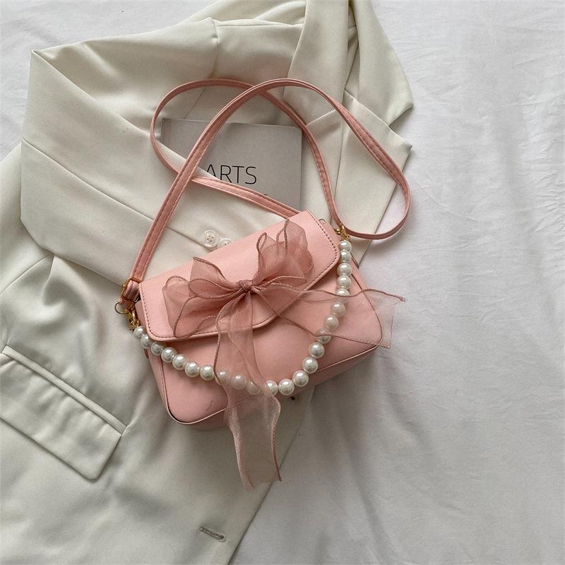 

Популярная в этом году модная темпераментная женская сумка-мессенджер с нежной жемчужной цепочкой, лето 2025, новая сумка-бант, тренд розовый