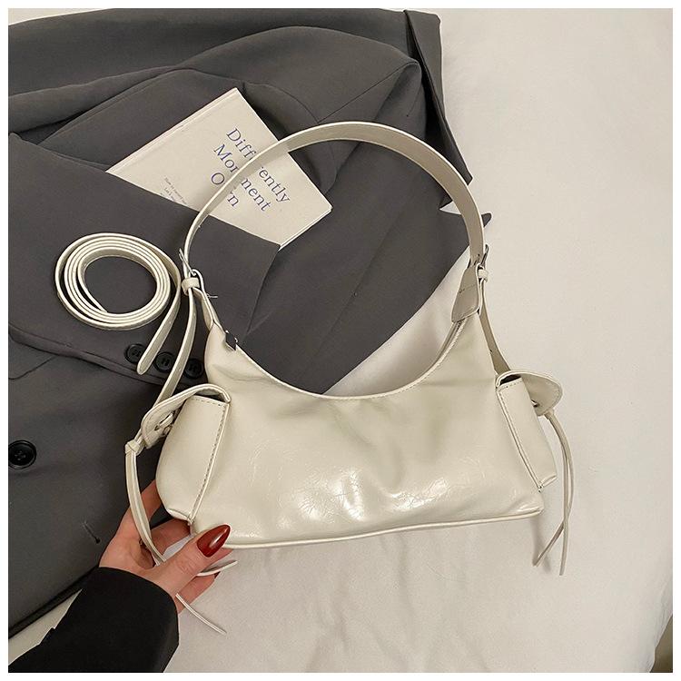 

Сумка подмышку женская лето 2025 новая модная нишевый дизайн на плечо сумка-мессенджер высококачественная текстура сумка-пельмень белый