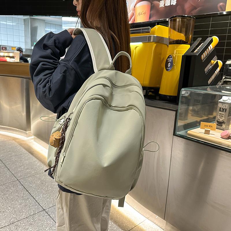 Casual solid color large-capacity schoolbag 2025 new versatile junior high school backpack college student travel backpack tide