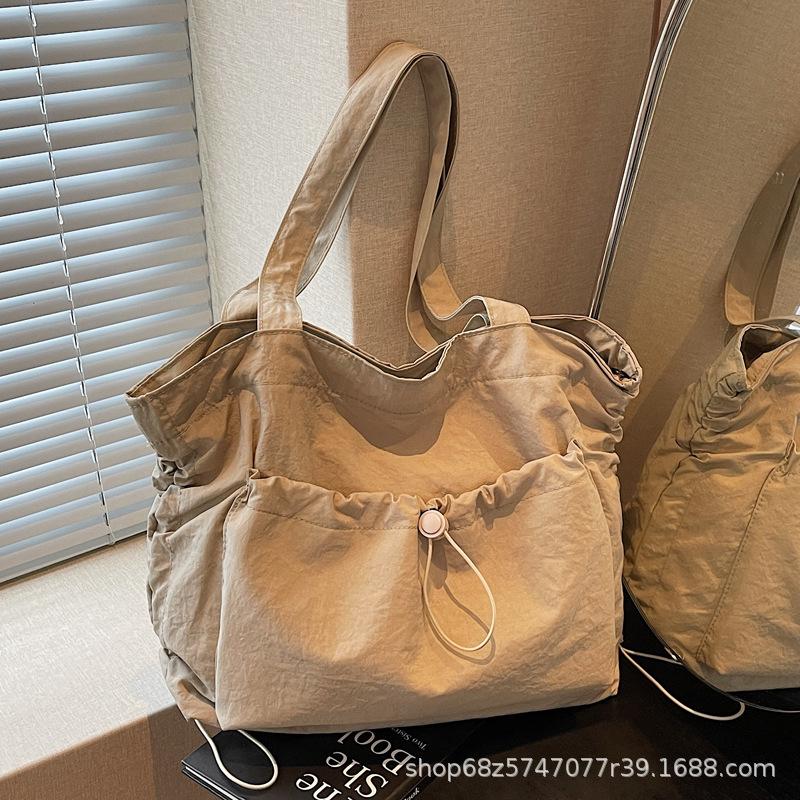 2025 new large-capacity drawstring canvas bag casual Korean version women's solid color daily commuting shoulder tote bag women