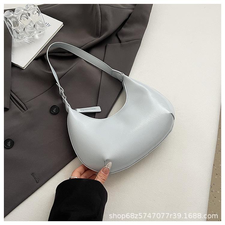 Small bag trend 2025 new fashion handbag high sense versatile women's bag single shoulder solid color half moon armpit bag