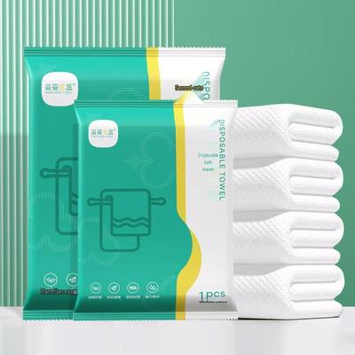 Serviette de bain douce en coton jetable emballée individuellement pour le voyage et l'hôtel
