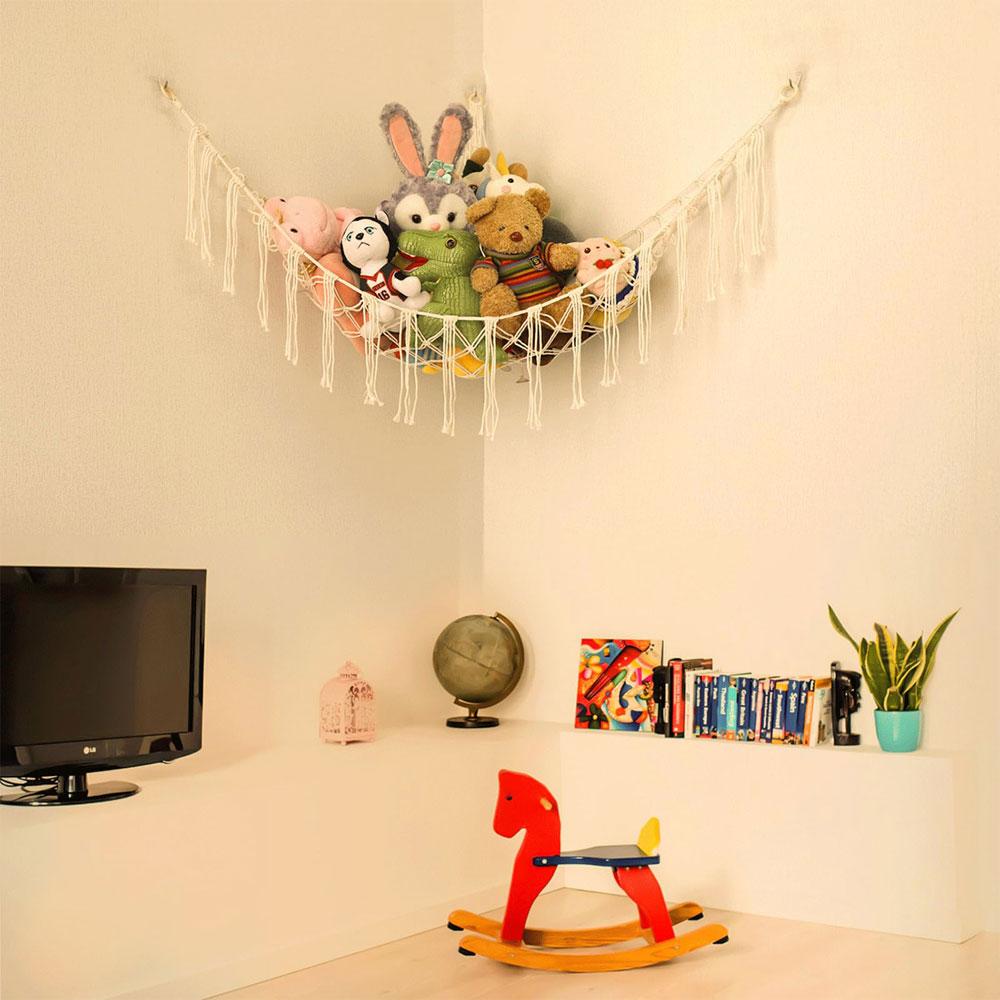 Toy hammock is hung in the corner and is equipped with a storage net, a toy storage bag, and a wall-mounted hammock.