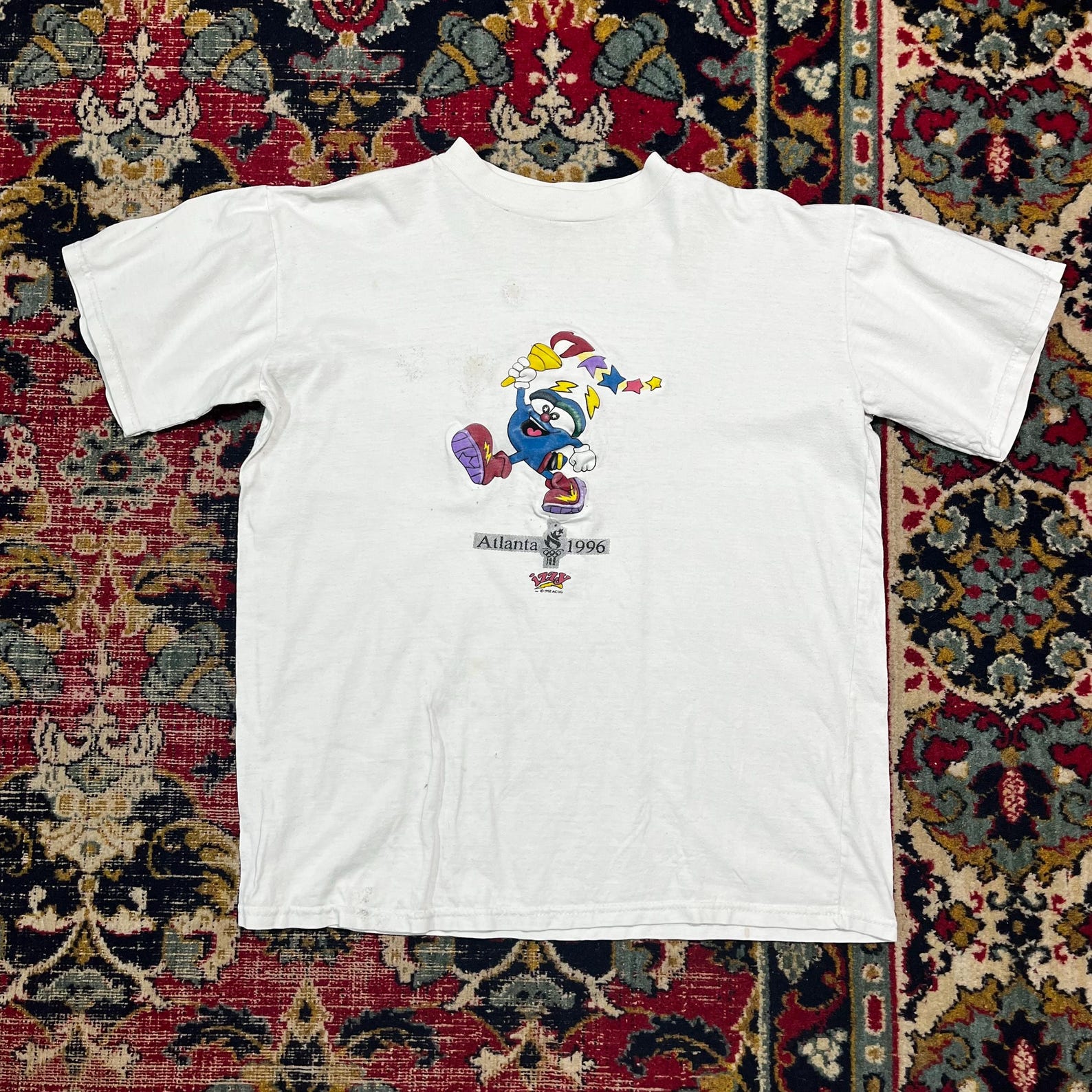 Title: Vintage 1996 Atlanta Olympics T-Shirt Izzy Mascot White Tee USA Games Size M 3XL