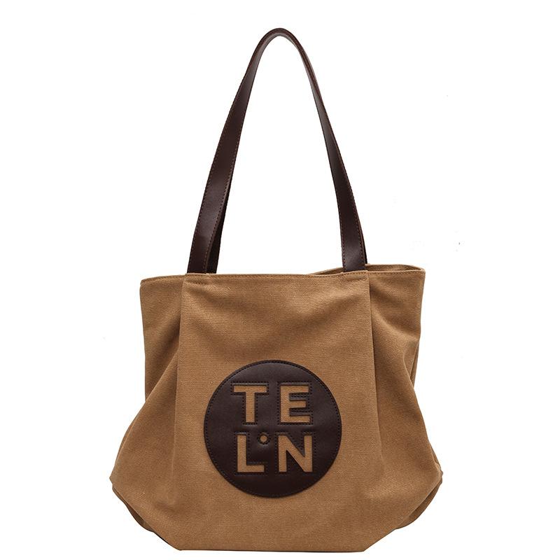 

Повседневная нишевая сумка премиум-класса для женщин, лето 2024, новая корейская версия, холщовая сумка, большая вместительная сумка-тоут для поездок на работу и обратно хаки