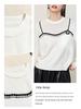 Elegant Women's Knit Top with White Lace Collar and Floral Brooch