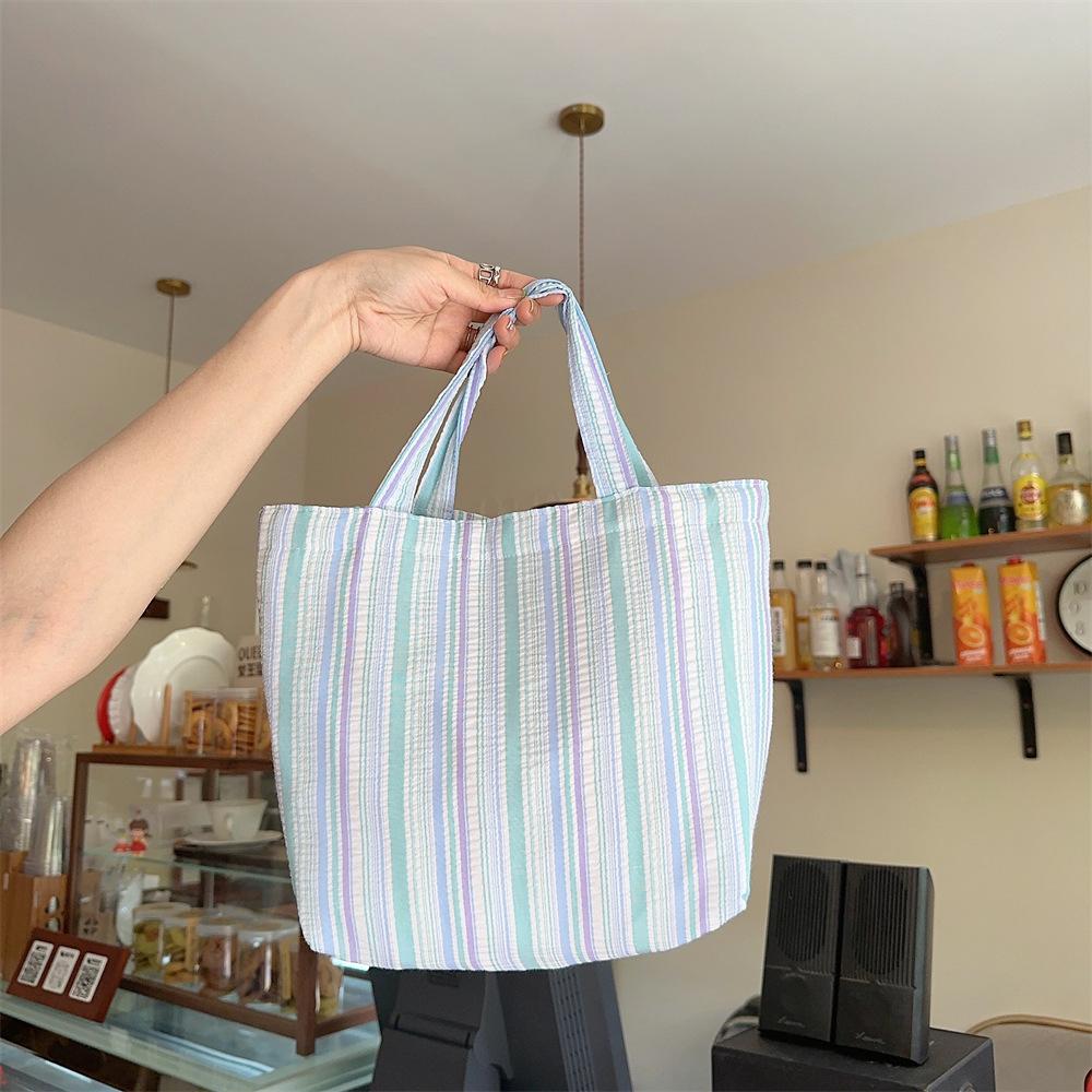 

Spring and summer new pleated striped canvas bag portable bento bag storage bag large capacity hand carry mommy bag