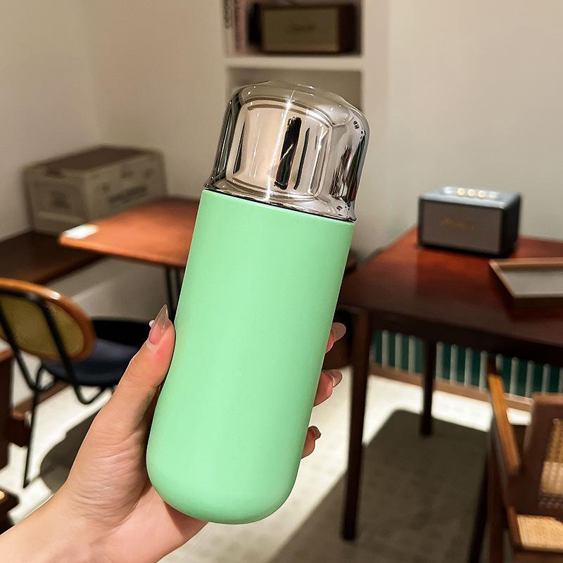 Miniature compact insulated cup with magnetic lid for making tea. Portable outdoor sports insulated drinking water bottle.