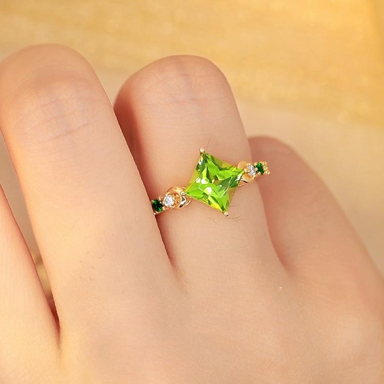 Yintai Fei Elegant Rhombus Facet Zircon Ring: 18k Gold-Plated Copper with Diamond and Green Peridot.