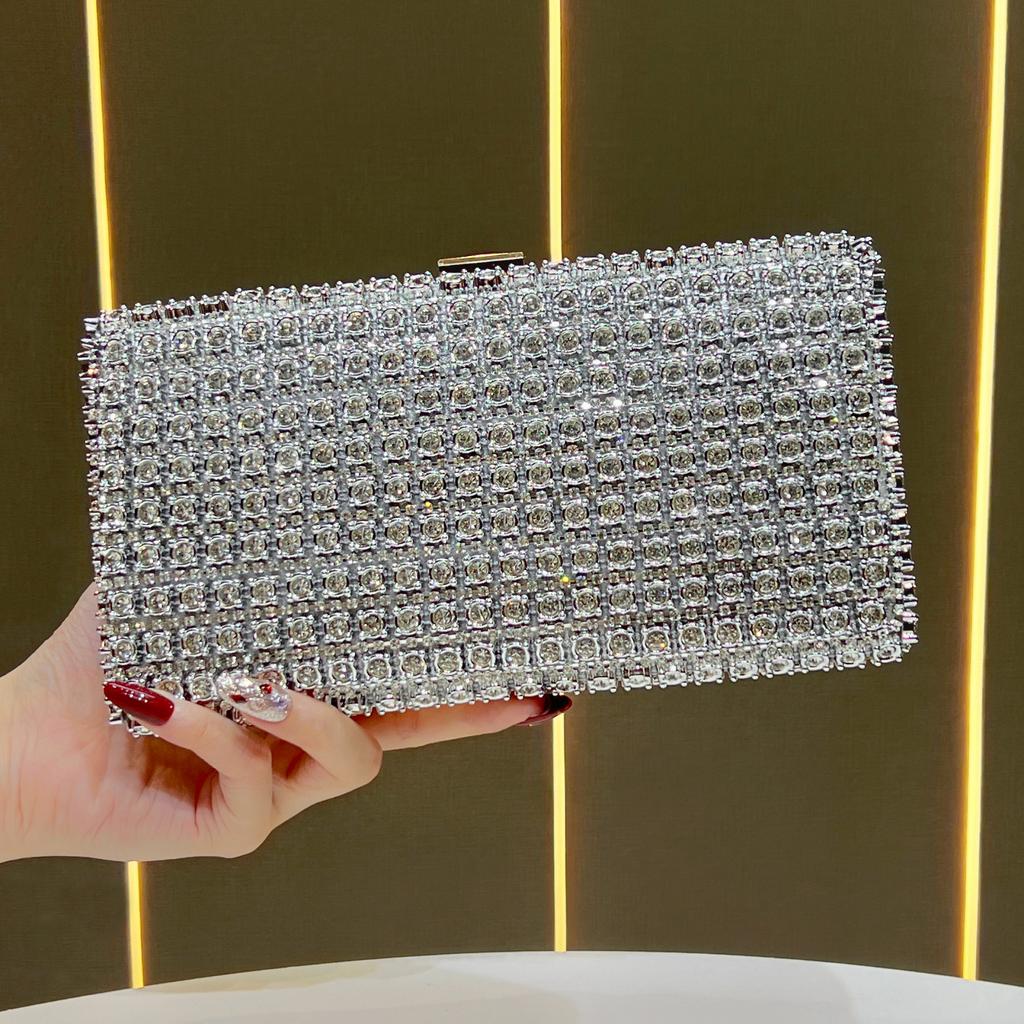 Lady Holding A Fashionable Evening Bag. Designer Water Droplet Chain Handbag for Ladies. Shoulder Bag for Ladies. Casually