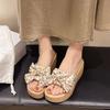 Thick-bottomed wedge slippers women's 2025 summer new muffin bow high-heeled small man one-word drag going out sandals