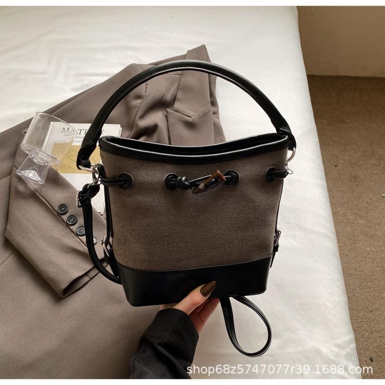 2025 new niche design canvas portable bucket bag women's simple high-end commuter shoulder messenger women's bag