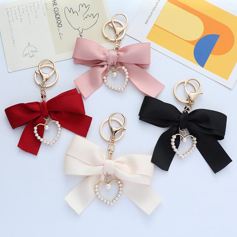 Elegant Pearl Strand Bow Keychain with Heart Charm, Octagonal Shape, Floating Fun-Themed Accessory, with Split Ring Closure for Handbags and Car Keys