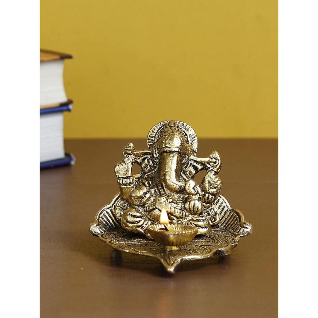 Golden Metal Handcrafted Lord Ganesha Idol with Diya On Leaf - Diya for Diwali, Ganesh Chaturthi - Diwali Diya for Puja Room