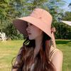 Beach sunshade sunscreen hat shows a small face and a big brim. Vacation sun hat for women