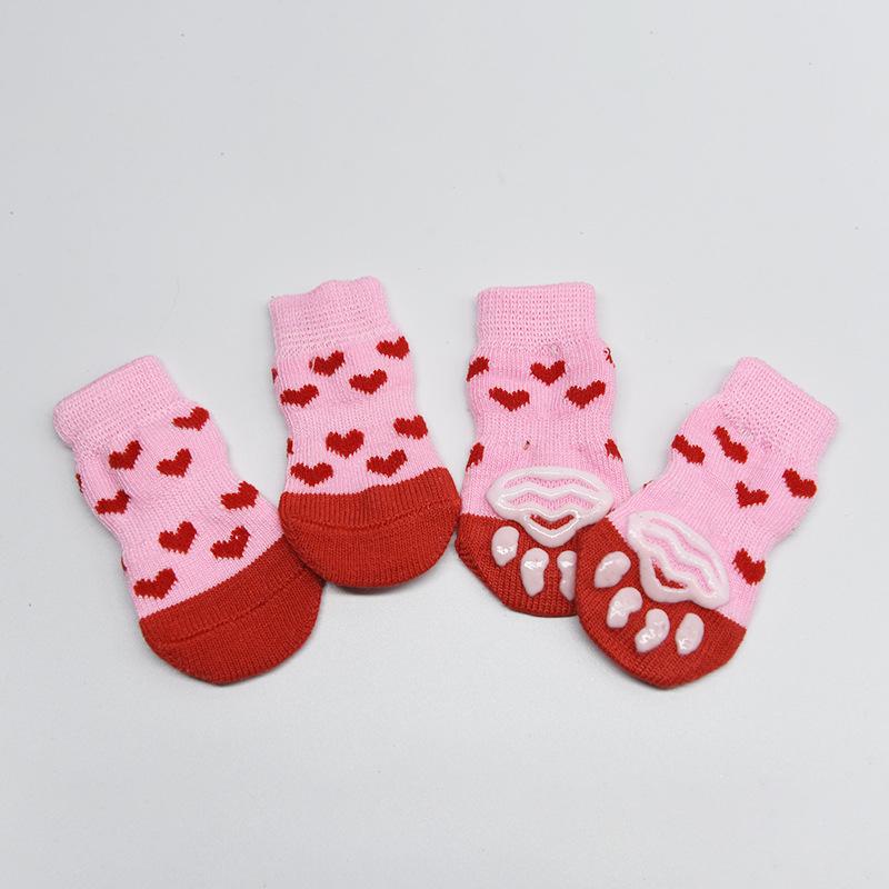 Four-pack of autumn/winter cartoon anti-slip socks for pets, including cat and dog warm socks with paw prints, perfect as a holiday gift.