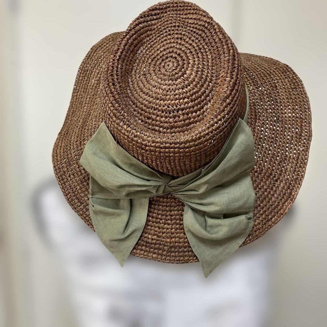 Used Low price wide brimmed straw hat with olive green ribbon